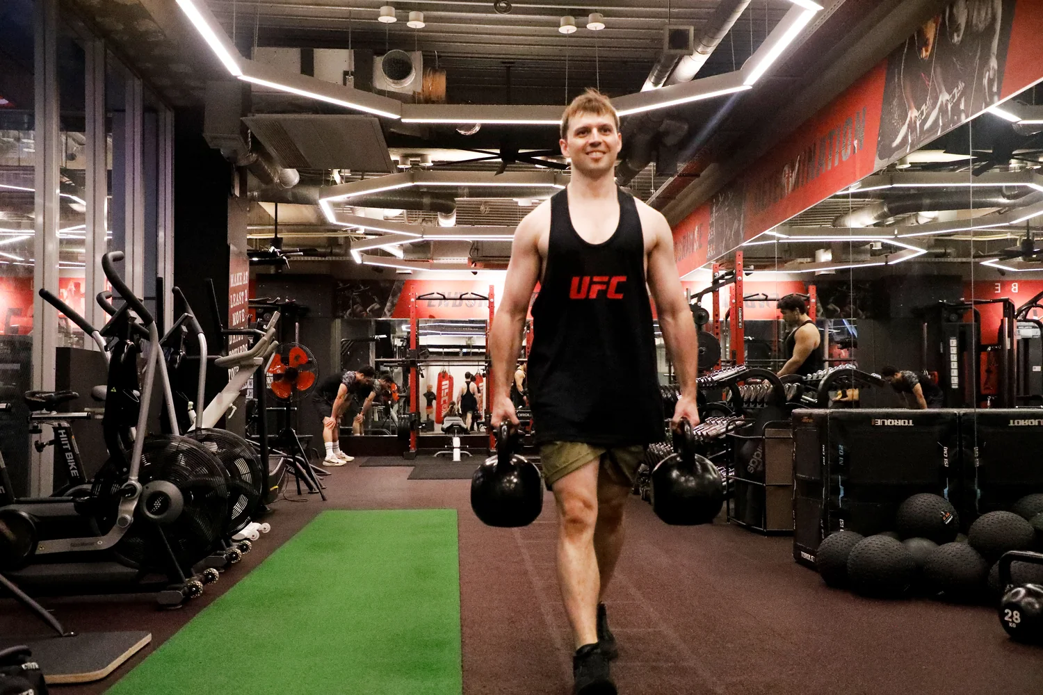 Farmers carry training with kettlebells at UFC Gym Yoga