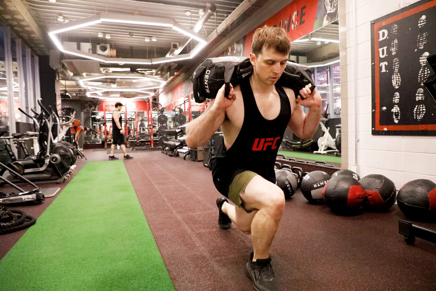 Sandbag lunges training at UFC Gym Yoga